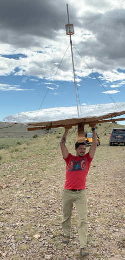 Victor holding up the 8ft parabollic antenna he built from cardboard to win 2nd plance in an antenna competition